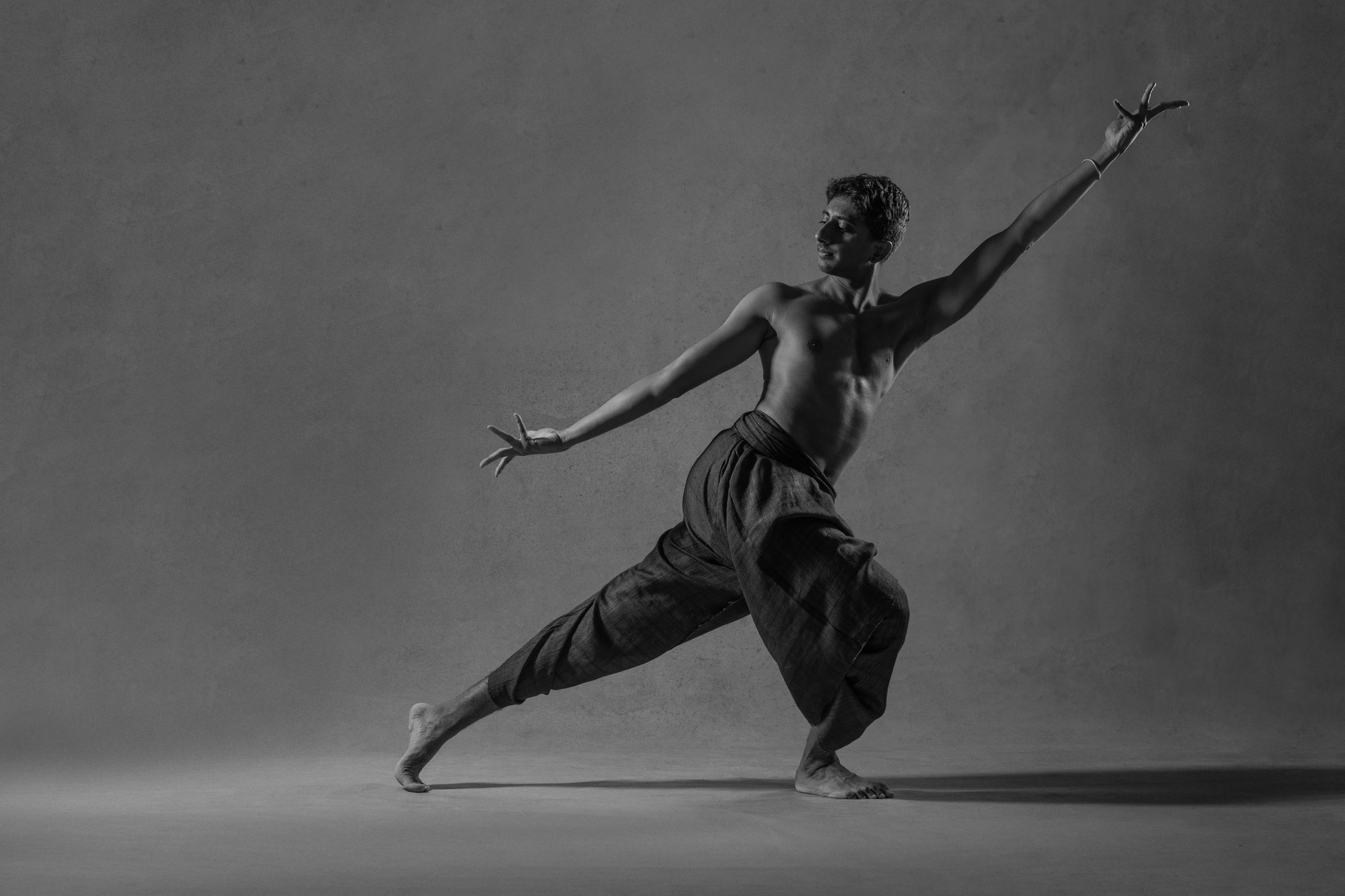 Vivek Ramanan in a dramatic lunge, black and white